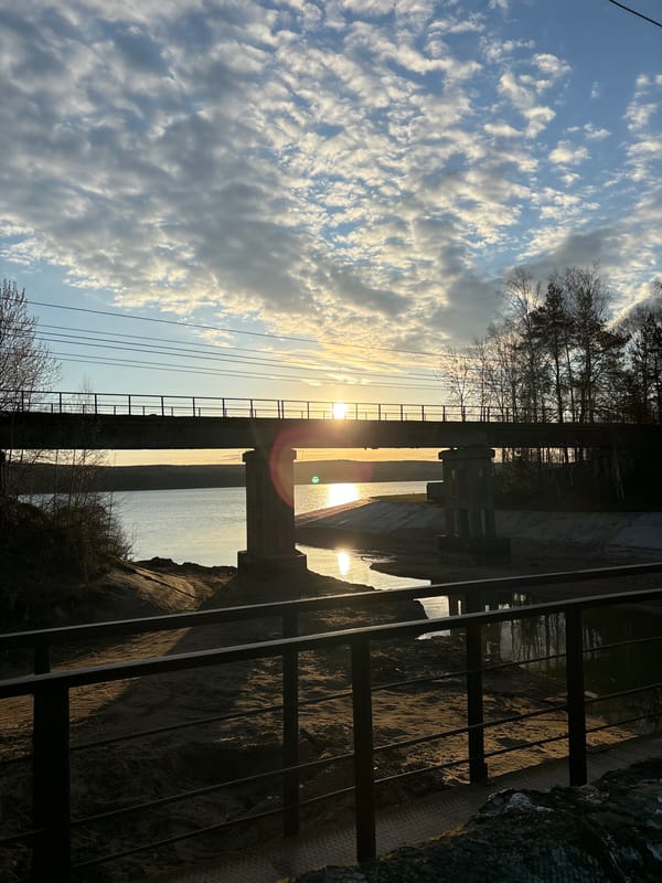 Dawn or dusk photographed over water near Chaikovsky bridge