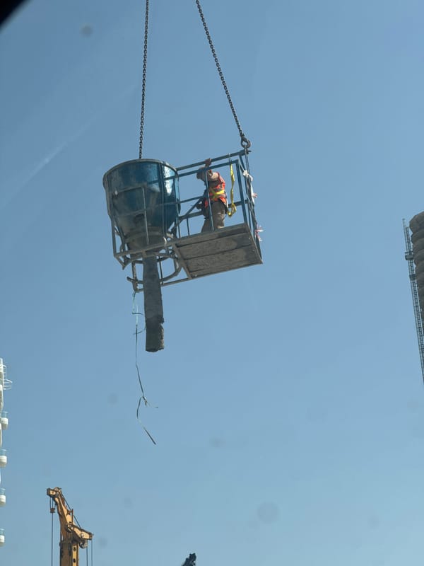 Construction worker operates from suspended concrete bucket in Dubai