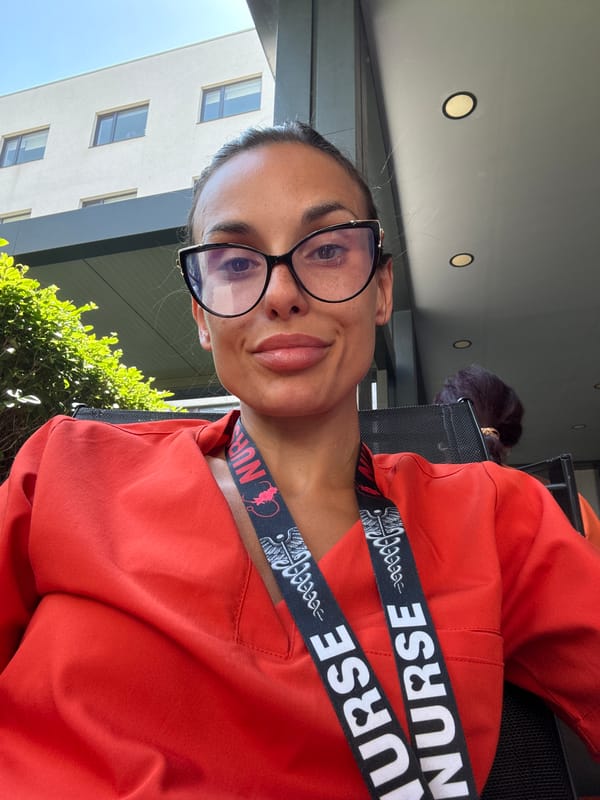Nurse in red scrubs snaps a selfie in Pleven