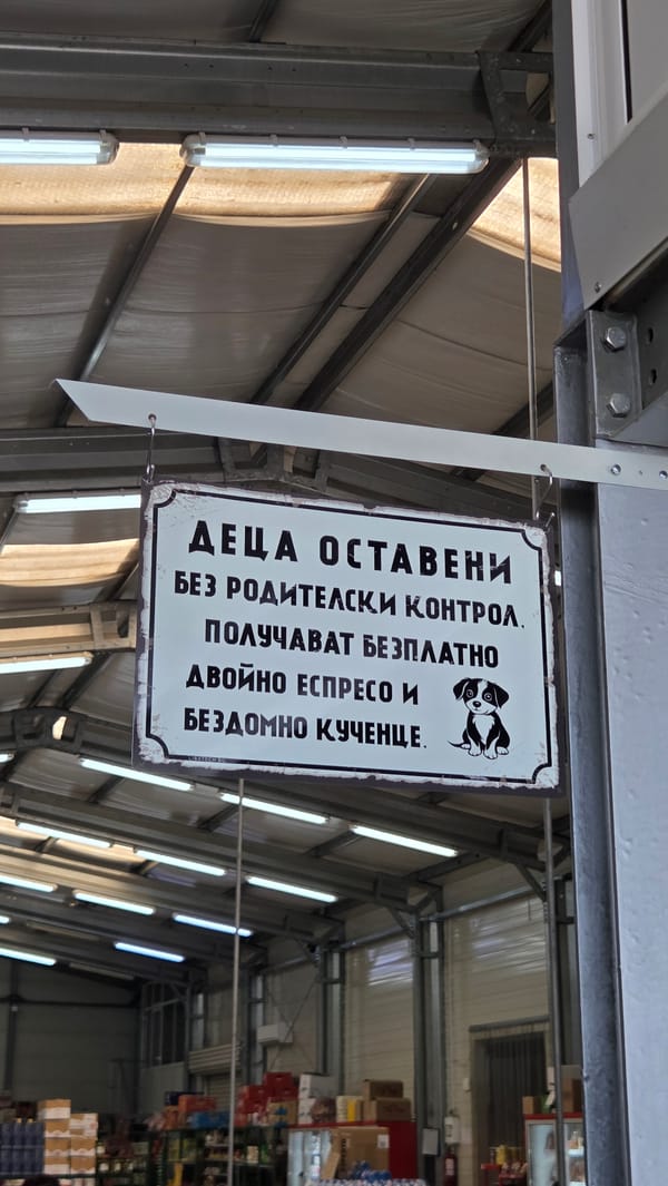 Dog-illustrated sign hangs inside a fluorescent-lit indoor space
