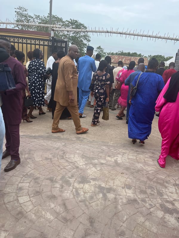 Public gathering documented in Abuja with diverse attendees queuing