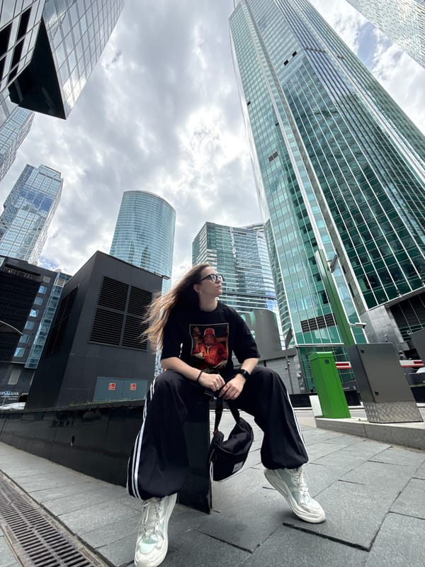 Woman sits on urban ledge in Khimki, Russia