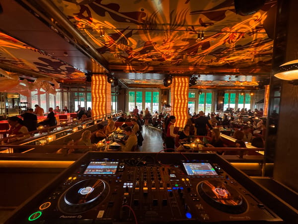 Female DJ performs at crowded London restaurant-bar venue