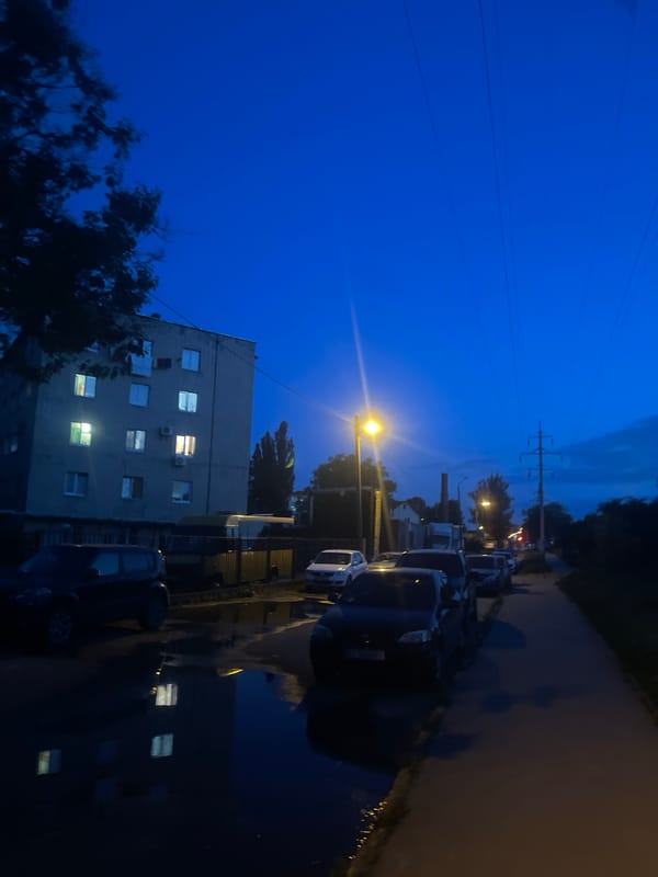 Evening scenes captured across urban area with Cyrillic signage