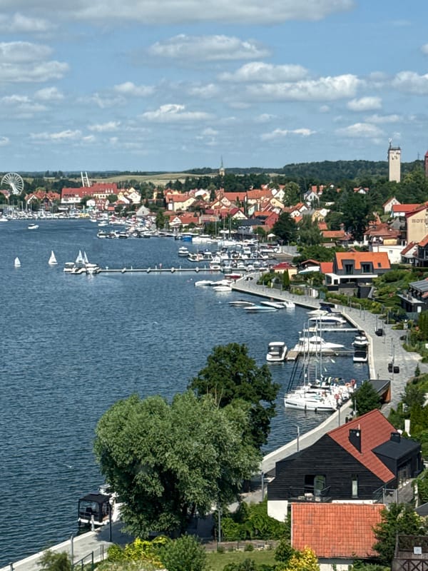 Mikołajki lakeside town: marina, forests, and active construction sites