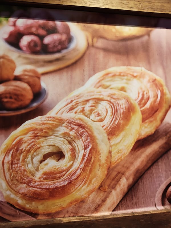 Spiral pastries and meat-filled baked goods photographed in Singapore