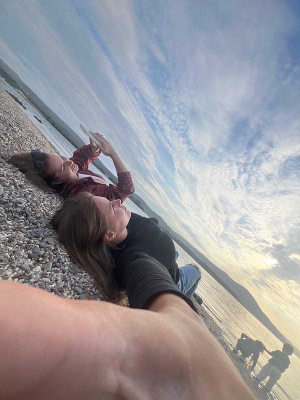 Women photograph themselves on Tivat beach
