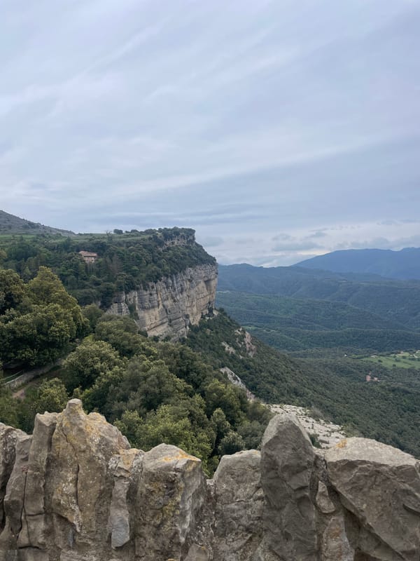 Tourists photograph scenic mountain views from Tavertet clifftops