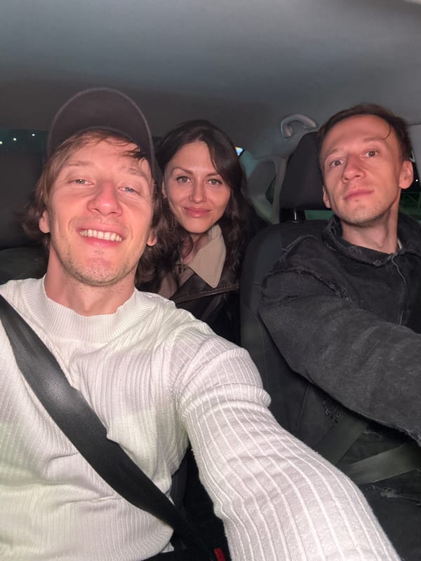 Three people inside a car at night in Saint Petersburg