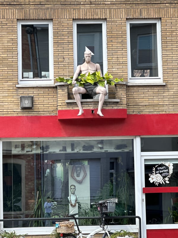 Street-level details from a Bruges neighborhood: architecture, murals, sculpture