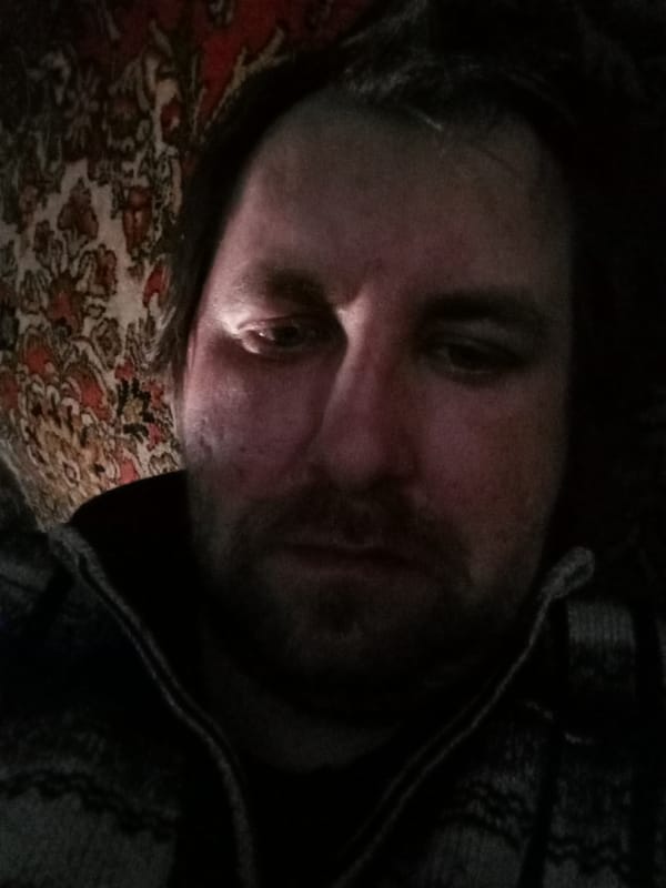 Portrait of unidentified bearded man captured in dim lighting