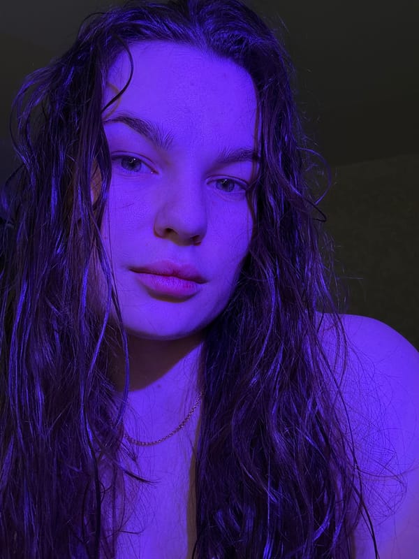 Woman photographed twice under blue lighting in Chaikovsky