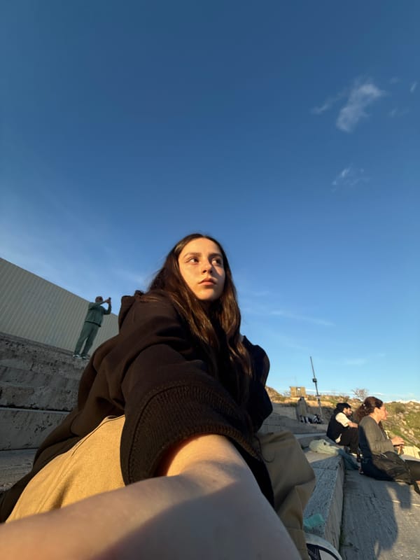 Tourist documents golden hour city views from Yerevan overlook