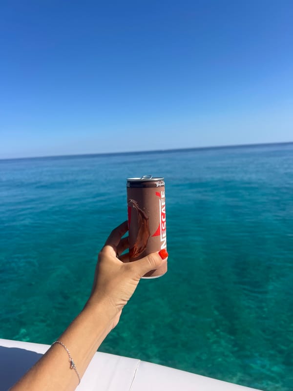 Nescafé in hand, drifting over clear turquoise water off Egypt
