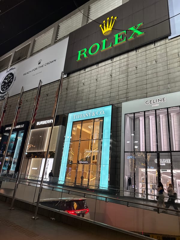 Nighttime luxury shopping district activity documented in Kuala Lumpur