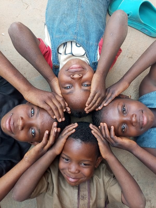 Children play with tire in circular formation, Tempure Nigeria