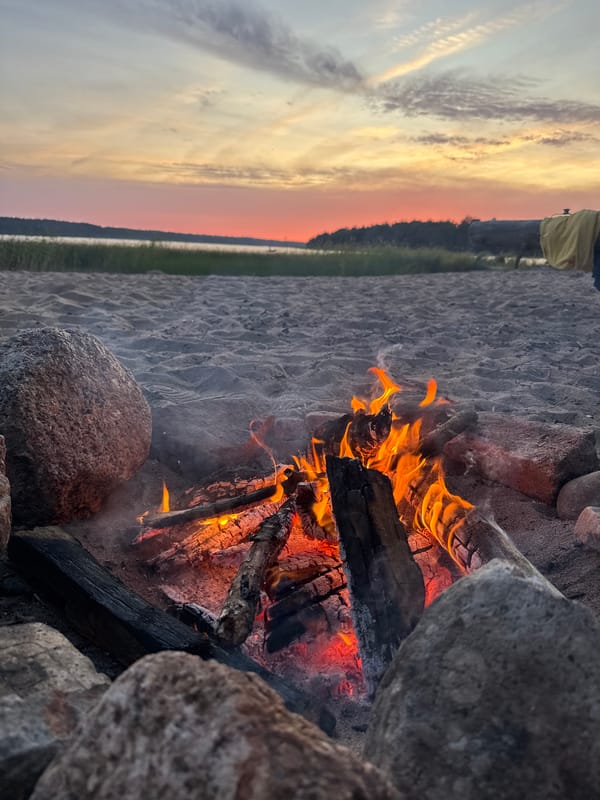 Beach bonfire at sunset on the Russian shore