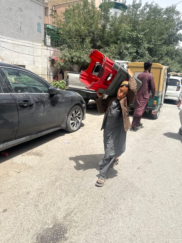 Man carries red object on Quetta street