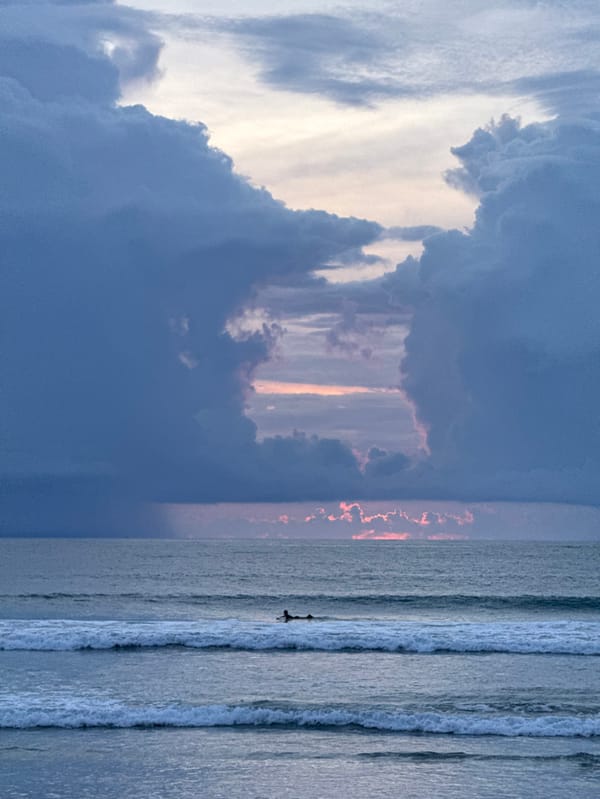 Storm clouds frame ocean view at Kuta beach