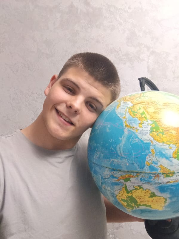 Young man poses with household objects in Russian home