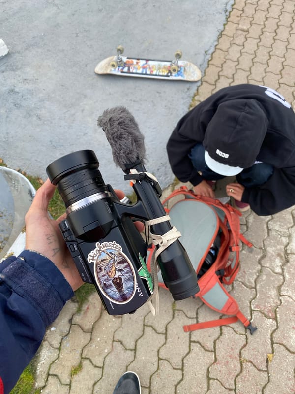 Person adjusts backpack contents on Ushuaia street