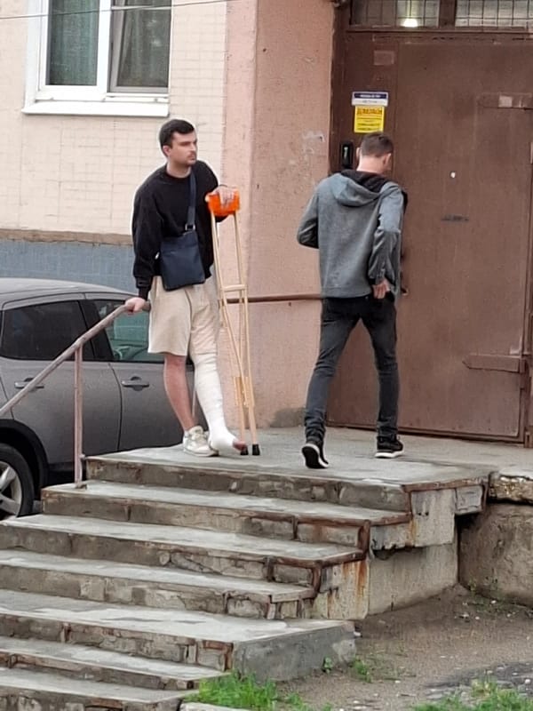 Foot traffic and parked cars in a quiet urban neighborhood