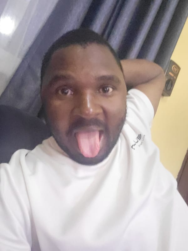 Man relaxes at home watching TV in Suleja