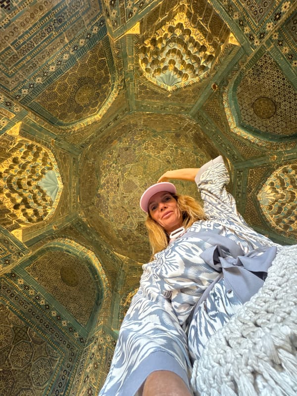 Vendor sells handmade sheep toys at Samarkand market