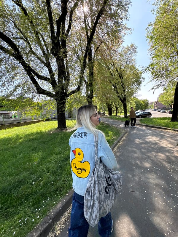 Person walks Milan park wearing Bieber cartoon duck jacket