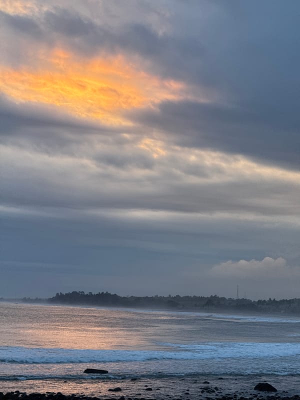 Two girls pose on beach during sunrise moment