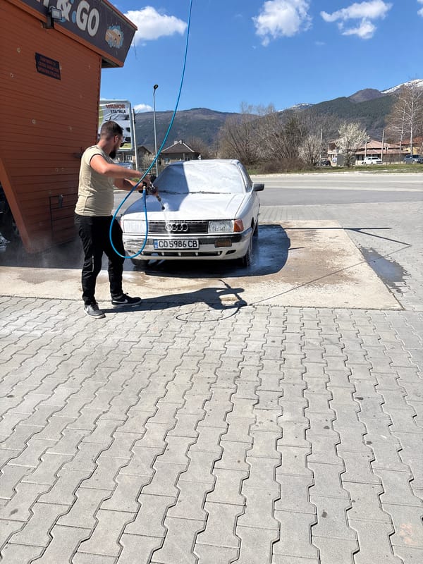 Man washes white sedan at Zlatitsa car wash facility