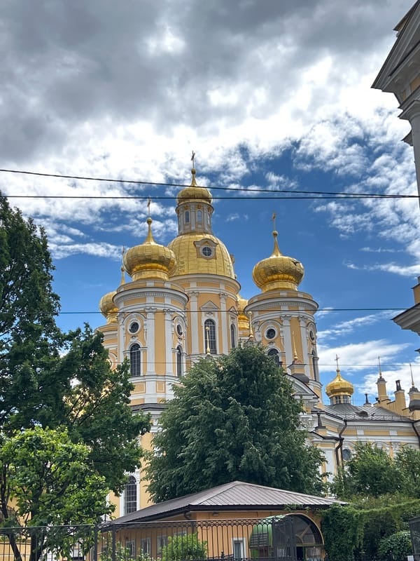 Golden domes and canal boats along a Russian riverfront