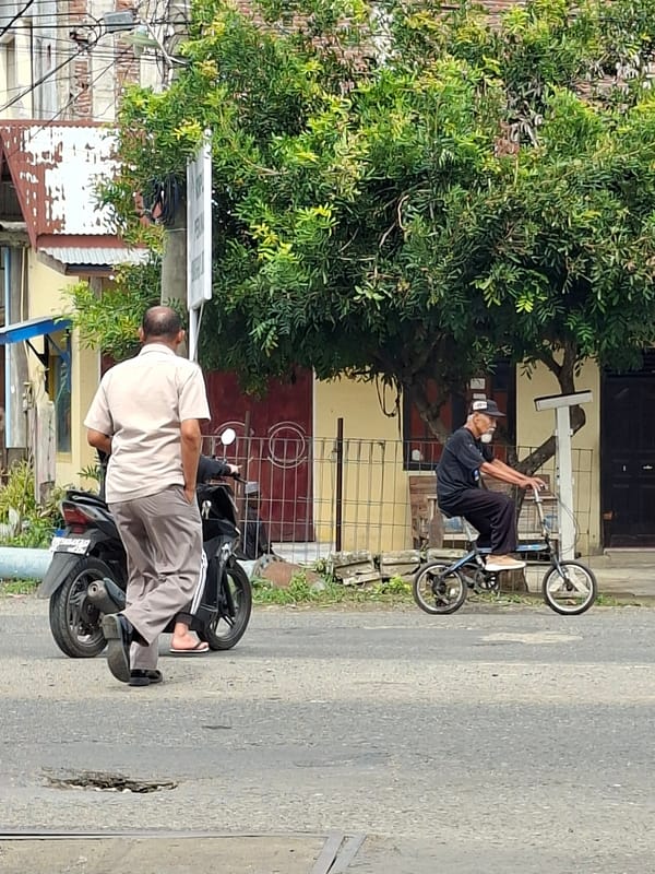 Everyday street traffic and activity in Lhokseumawe, Indonesia