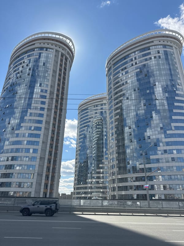 Morning urban scenes captured in Novosibirsk featuring buildings, fountain