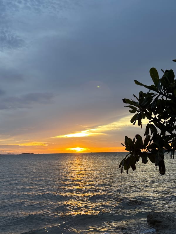 Dusk light across Pattaya — ocean, road, and texture