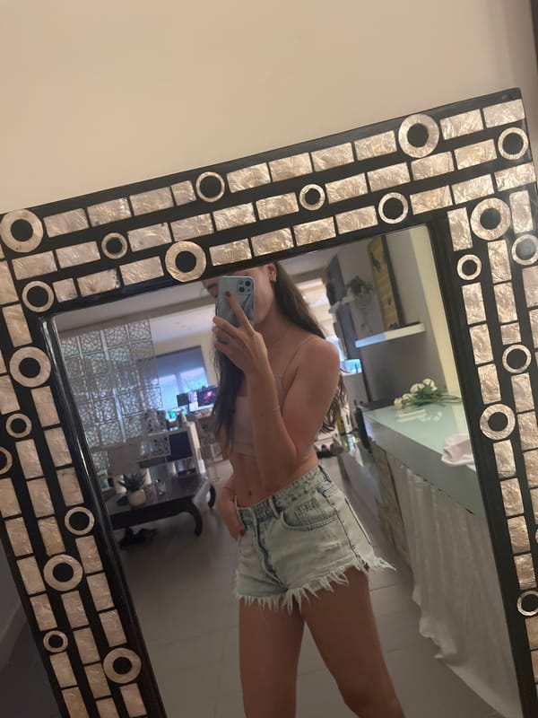 Person takes mirror selfie indoors in Alicante, Spain
