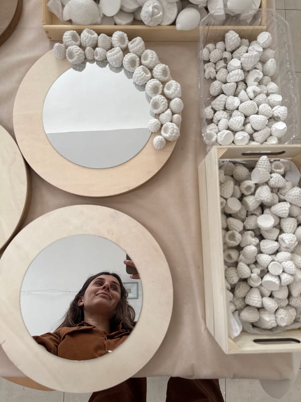 Handcraft display features wooden mirrors and plaster fruits in Tel Aviv