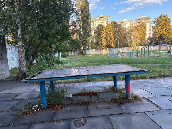Wandering a graffiti-tagged Kyiv courtyard on a summer afternoon