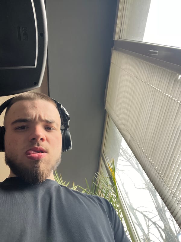 Man photographed making playful expression while wearing headphones in Bulgaria