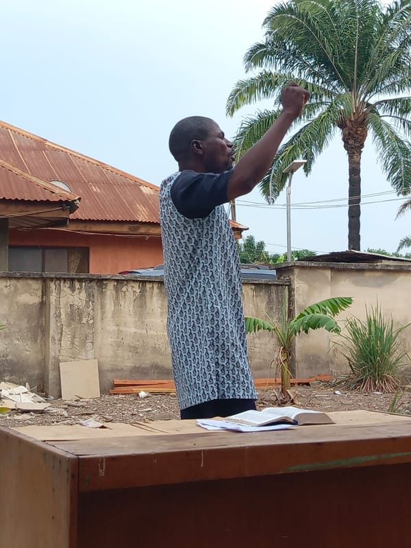Man delivers outdoor sermon in Akwanga courtyard