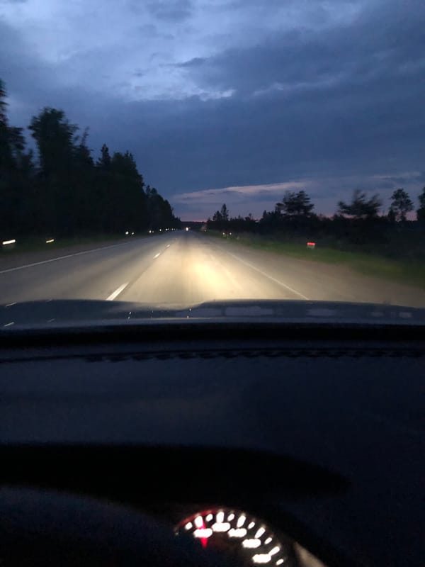 Vehicle travels highway near Kingisepp during twilight hours