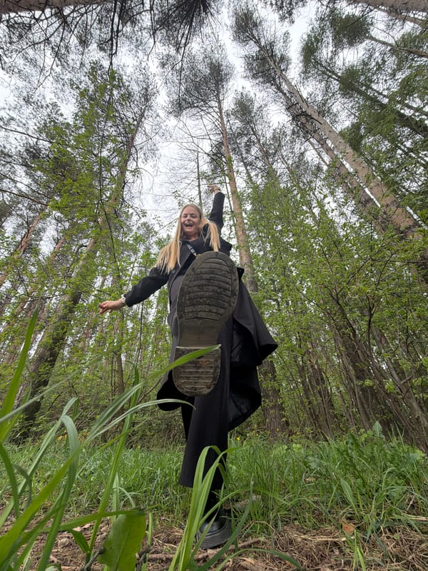 Woman photographs herself in Izhevsk forest during morning outing