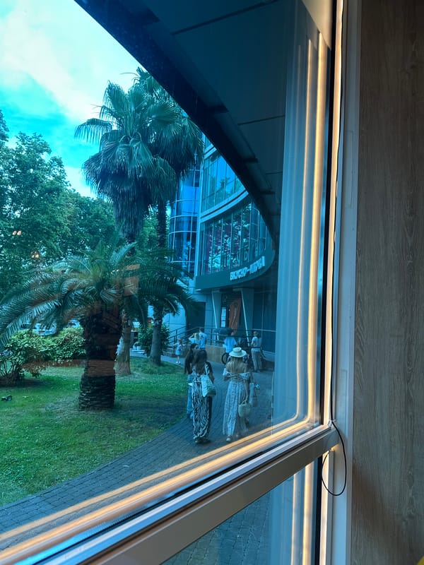 Lunch break at a Sochi McDonald's near a glass-facade landmark