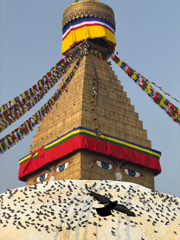 Temple visitors spin prayer wheels at Boudhanath Stupa, Kathmandu