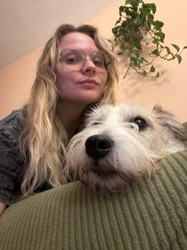 Person and scruffy white dog share a candid Tel Aviv moment.