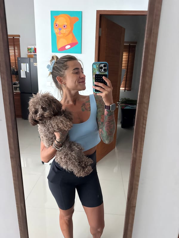 Back-to-back selfies in a Thep Krasatti room, dog in tow