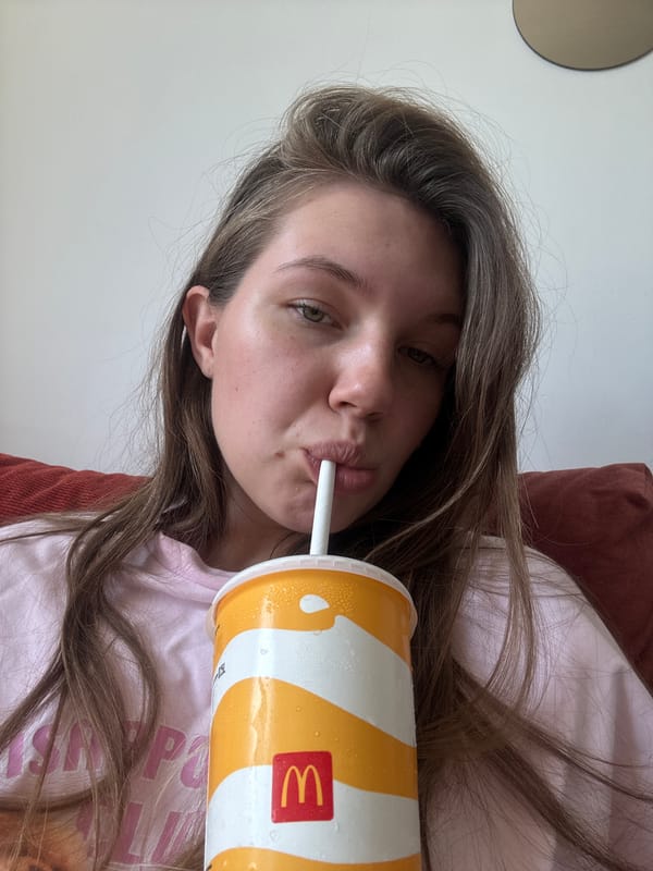 Woman drinks McDonald's beverage while resting in Belgrade suburb