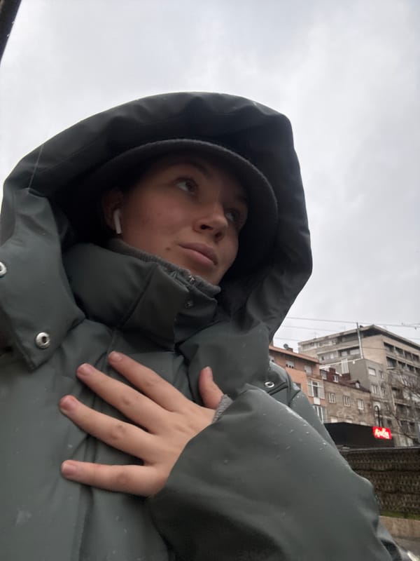 Pedestrians navigate rainy Belgrade streets during afternoon downpour