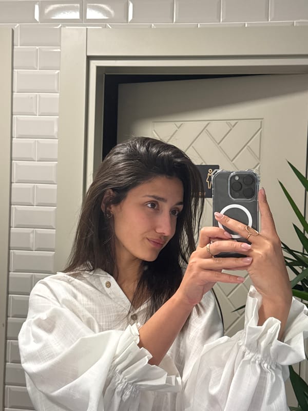 Woman takes mirror selfies in Montenegro restroom