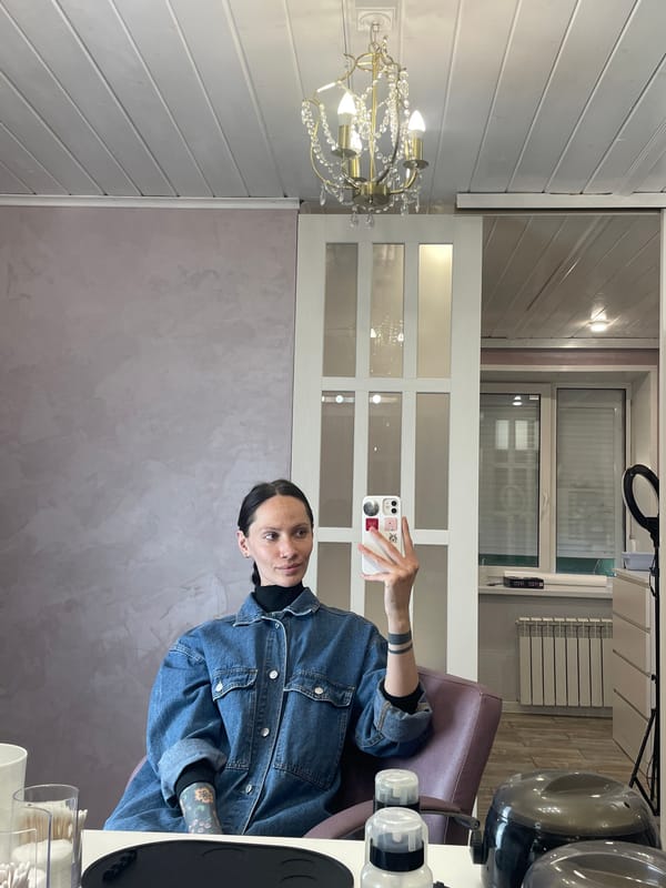 Woman takes mirror selfie at beauty salon in Izhevsk